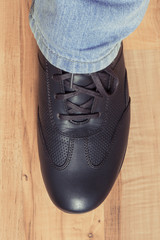 Brown shoes for men on rustic board, male footwear concept