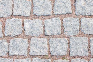 Иackground stone pavement of gray granite.