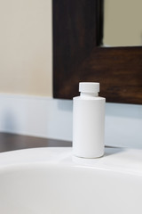 White bottle on a wooden background and shadow. Chemical Solvent Bottle with Cap