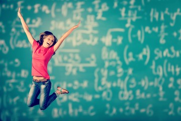 Little pupil jump high on the blackboard background