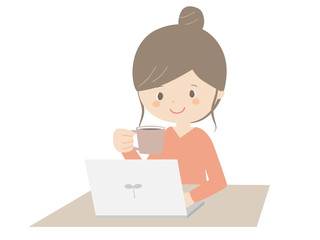 Woman drinking coffee while looking at the computer.