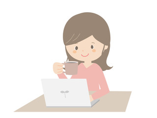 Woman drinking coffee while looking at the computer.