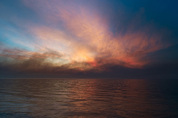 Fototapeta na wymiar Sea sunset. Smoke wildfires sweeping across the sky.