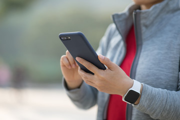 Asian woman using smartphone outdoors
