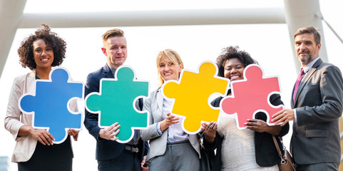 Business people connected by puzzle pieces