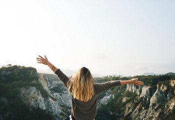 Carefree woman arms outstretched on the mountain - obrazy, fototapety, plakaty