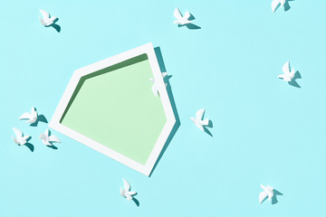 Minimal creative layout with white dove and green house shape