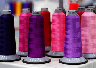 Colorful row of textile threads .