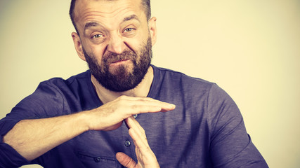 Man showing time stop gesture