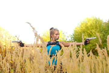 A young girl is dressed up in a military outfit.
She is seen observing the area in tall grass.
She...