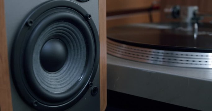 A Vibrating Sub-woofer on a Retro Speaker Monitor Playing Music from a Vinyl Player