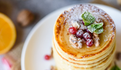 Delicious fresh beautiful pancakes with citrus honey and jam
