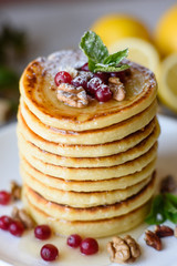 Delicious fresh beautiful pancakes with citrus honey and jam