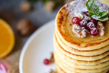 Delicious fresh beautiful pancakes with citrus honey and jam