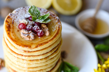 Delicious fresh beautiful pancakes with citrus honey and jam