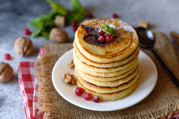 Delicious fresh beautiful pancakes with citrus honey and jam