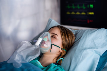 Infected patient in quarantine lying in bed in hospital, coronavirus concept.