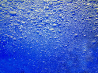 Water in the swimming pool is blue. Background. Details about water. Drops of water. Blurred. Shaded.