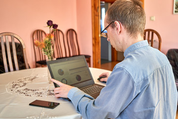 Fototapeta na wymiar Businessman working on laptop at their home office