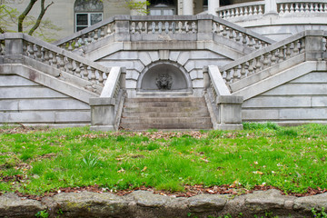 Detailed Stone Steps With a Turned Off Fountain Leading Up to an Abanoned Estate From a Grass Courtyard