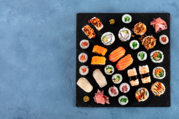 Large sushi set, shot from the top with copy space. Many different maki, nigiri and rolls