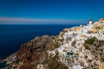 Overlooking the town of Oia on the edge of the beautiful Caldera ocean on the island of Santorini,...