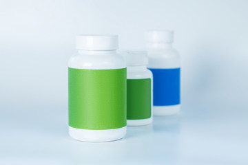 Three bottles of vitamins in one row next to each other