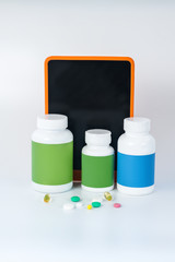 Three bottles of vitamins next to the smartphone