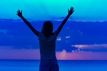 Woman with arms wide open enjoying ocean tropical time.