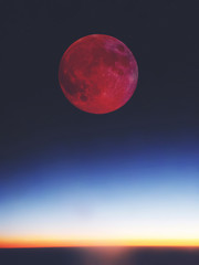 Fototapeta premium Full red bloody Moon setting / rising above the horizon.