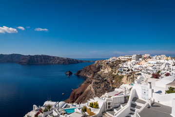 Overlooking the town of Oia in Santorini with the beautiful blue Caldera ocean in the distance
