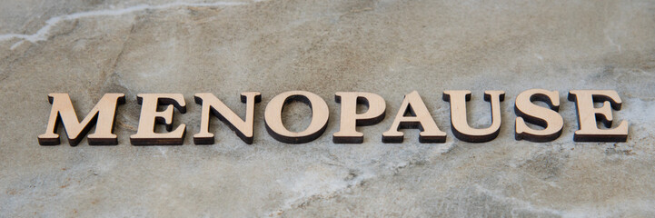 menopause , writen wooden letters on stone background