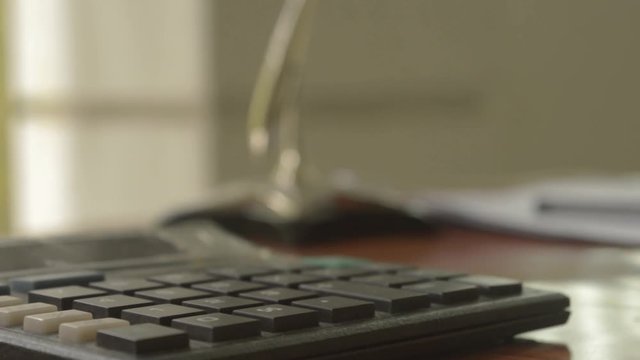 Close up of a calculator placed on office desk. Out of focus loan application form at a distance. Business Finance Concept. Vintage background. Isolated. Copy space room for text.