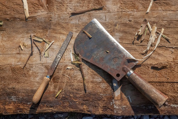 Hatchet and Rasp on Wooden Desk horizontal