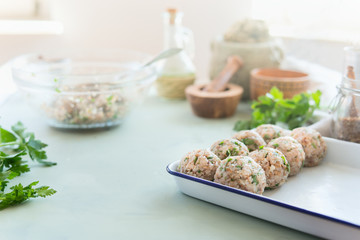 Fototapeta na wymiar Tasty vegan buckwheat balls on kitchen table with ingredients. Healthy home cooking and eating