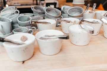 there are many cups of sugar on the wooden table