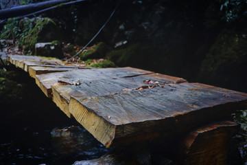 Rustic wooden footbridge close by Intsra waterfall - Georgia
