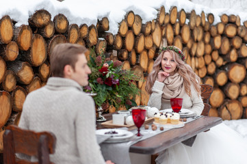 Cheerful bride is tenderly looks at her groom. Selective focus on the girl. Winter wedding