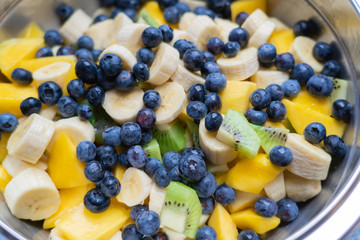 Fruit salad with fresh blueberries, bananas, kiwi and mango