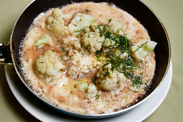 Cooking. Frying Broccoli in a pan with a liquid egg