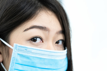 Close up woman with headache wearing mask for protect Covid-19