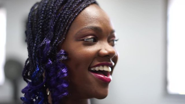 Black Teenaged Girl at Hair Salon Smiles at New Look, Close Up, Shallow Focus