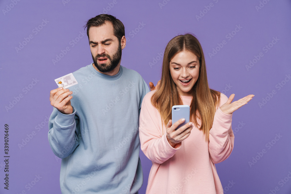 Canvas Prints happy girl using mobile phone near her displeased boyfriend