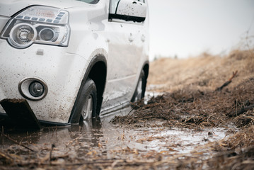 SUV stuck in a swamp close up.