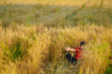 young indian child playing at wheat field, Rural india