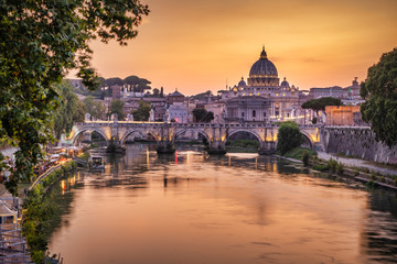 Fototapeta na wymiar View of the Tiber bridge St. Angelo and St. Peter's Cathedral