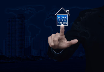 Businessman pressing work from home flat icon over world map, modern city tower and skyscraper, Business social distancing concept, Elements of this image furnished by NASA