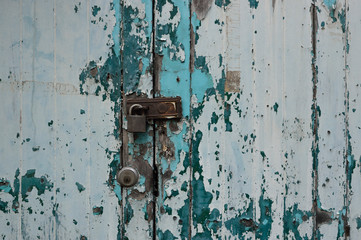 Rusted keys to lock vintage old green wood door for background