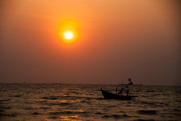Fototapeta na wymiar A boat on the sea at sunset