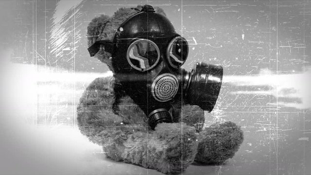Teddy bear wearing gas mask with vintage film effect.